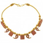 A gold necklace with red stones and a yellow chain.