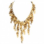 A necklace made of gold leaves and white beads.