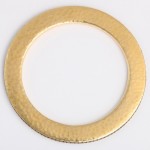 A gold colored metal ring sitting on top of a table.
