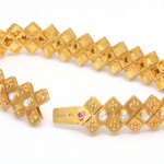 A gold bracelet with diamonds and rubies.