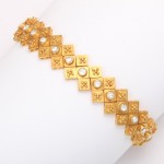 A gold bracelet with a diamond shaped design.